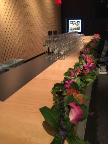 The length of the bar was lined with calla lilies mixed with greens.